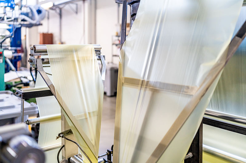 Web folding application where the web is entering a forming frame