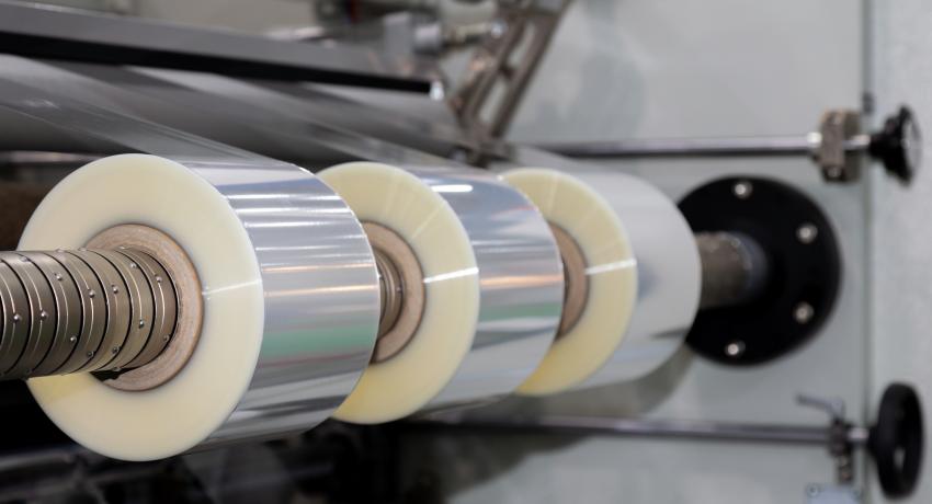 Plastic film slitting and rewinding