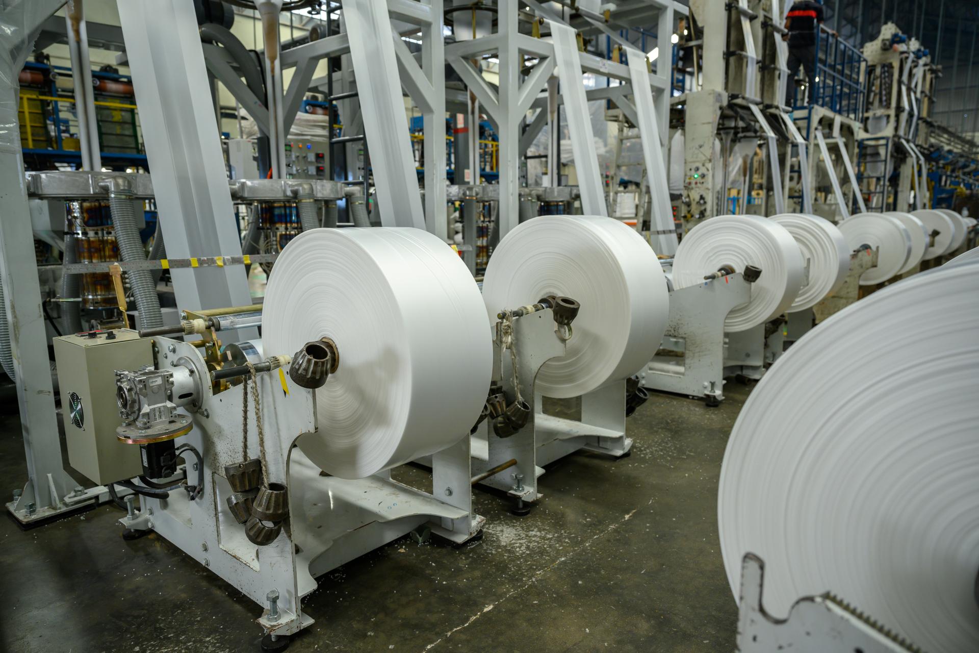Blown film production lines with multiple winding stations in a modern converting facility